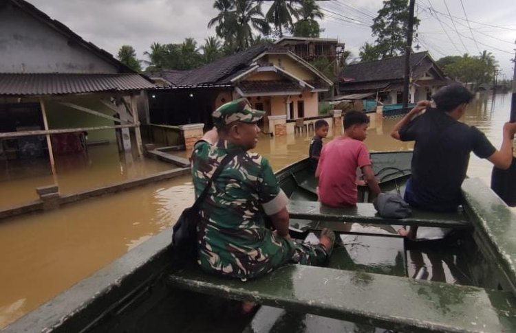 Monitoring Banjir Meluas di Pagelaran–Patia, Pelda Agus Rizal Evakuasi Warga Pakai Perahu